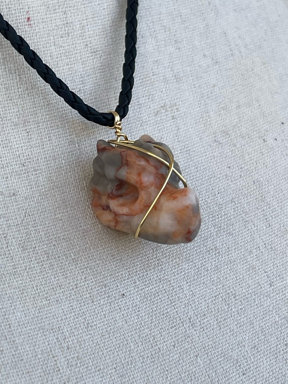 Crazy Lace Agate Dragon Skull Necklace Front Facing on Black Braided Cord